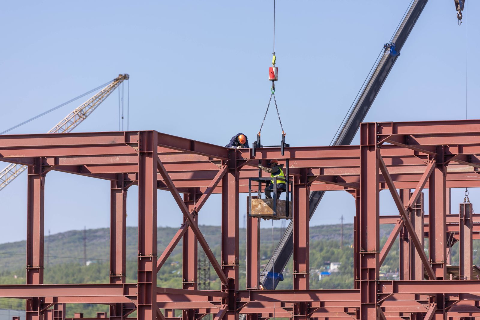 Crew assembling a steel building frame